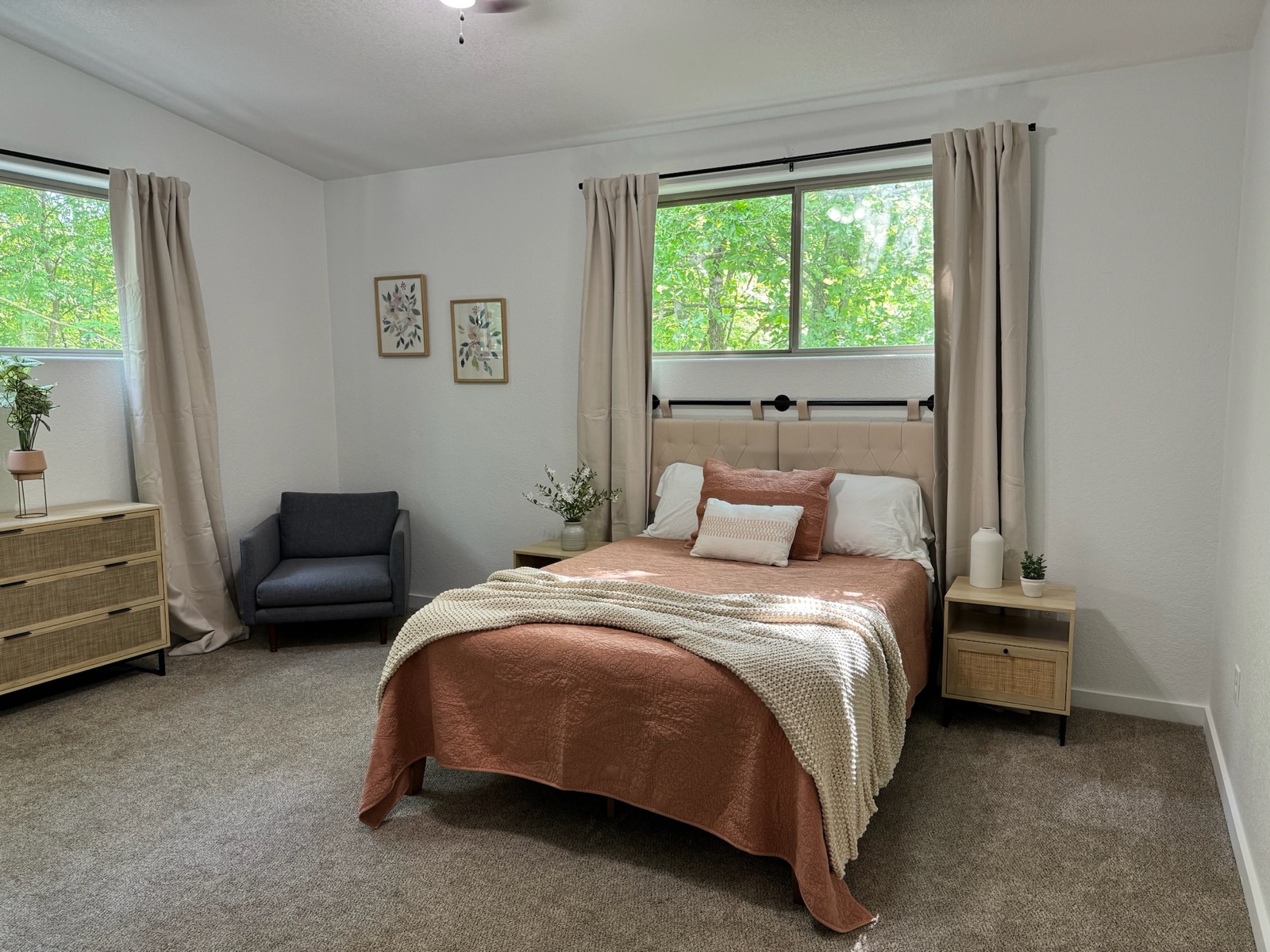 Bedroom with queen bed and forest-view windows