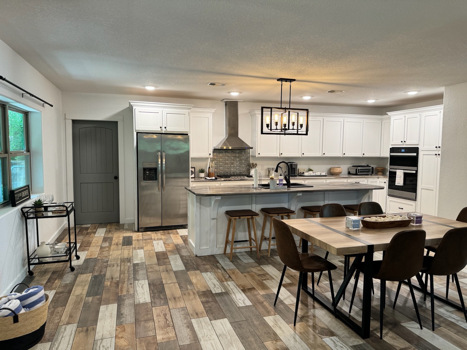 Full kitchen with island seating and stainless appliances