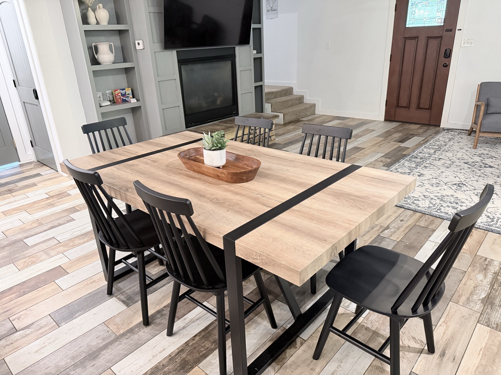Living room and dining table by the stone hearth, with board games out and ready